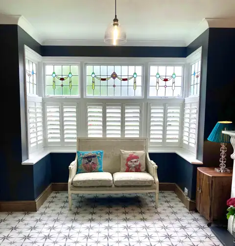Cafe style hardwood shutters on a bay window