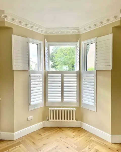 Tier on tier hardwood shutters in a bay