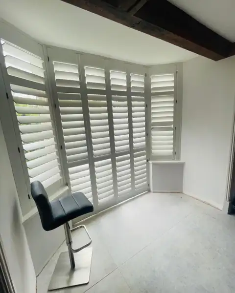 Tracked hardwood shutters on patio doors